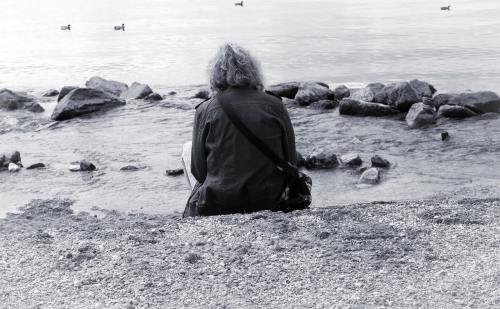 坐在海边的孤独人物背影