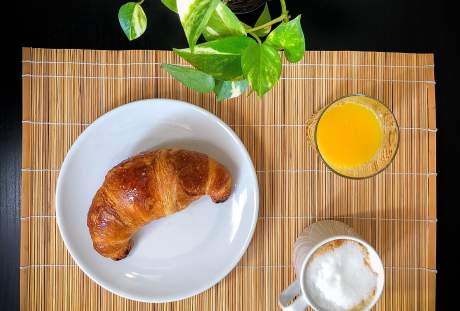 一杯咖啡与橙汁和牛角面包早餐图片